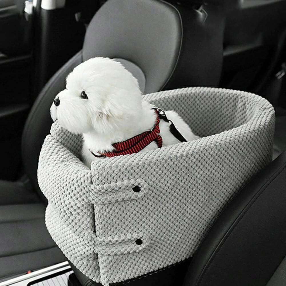 Weißer Hund in einem grauen Autositz für Haustiere. Bequemer, sicherer Hundesitz für Reisen. Perfekt für kleine Hunde im Auto.