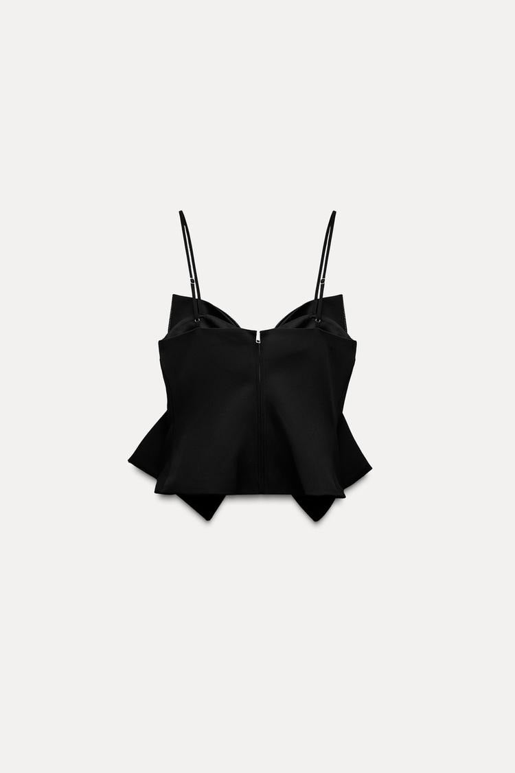 Schwarzes Bustier-Top mit Spaghettiträgern und asymmetrischem Saum. Modisches Damenoberteil, ideal für trendige Outfits und elegante Anlässe.