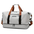 Graue Reisetasche mit braunen Griffen, wasserdicht, geräumig, ideal für Reisen und Sport.