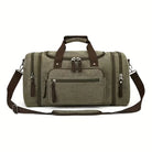 Olivgrüne Reisetasche aus Canvas mit braunen Griffen und Schultergurt, vielseitig und geräumig.