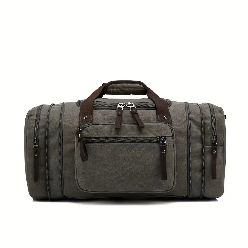 Graue Reisetasche aus Segeltuch mit Reißverschlusstaschen und braunen Griffen.