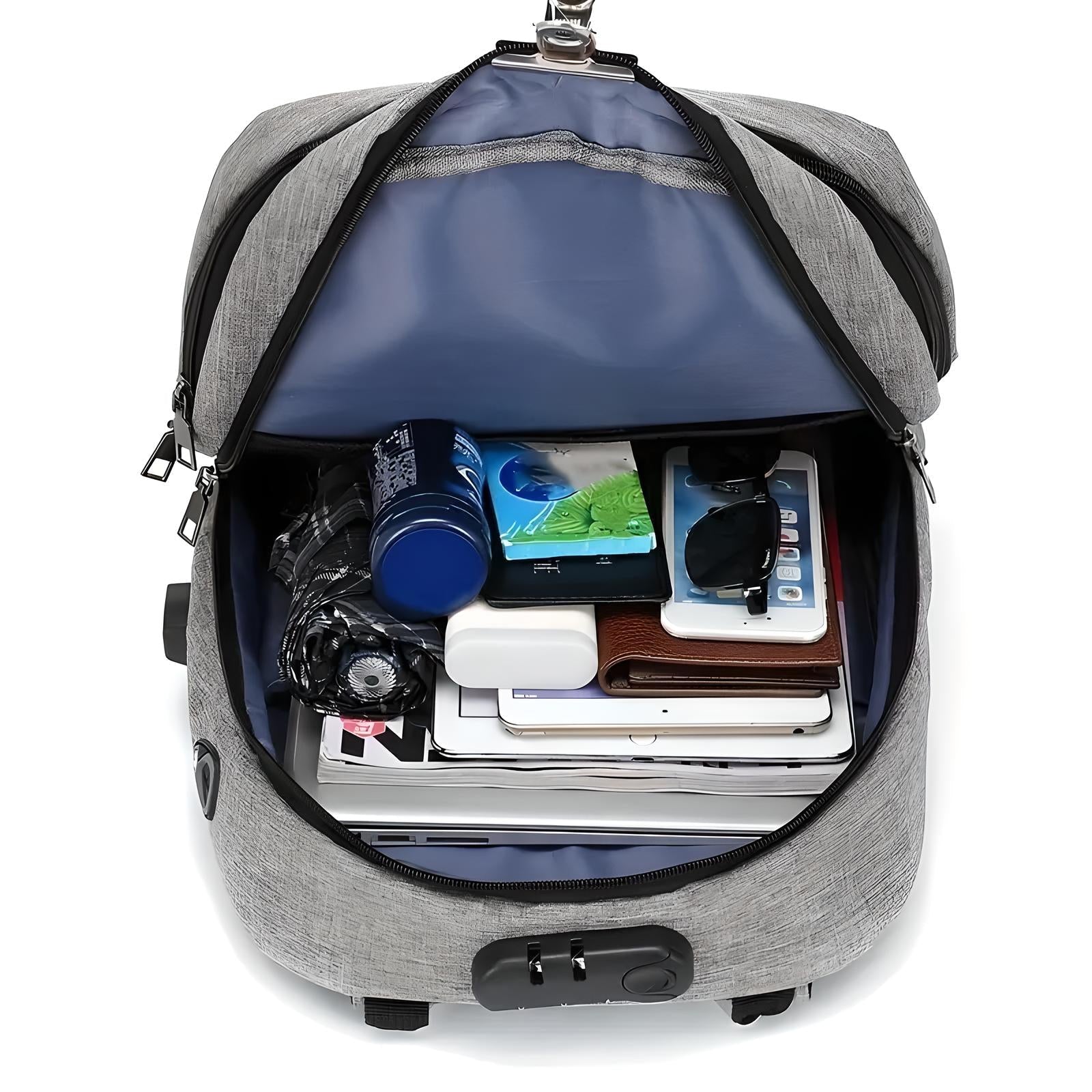 Grauer Rucksack mit Laptopfach, geöffnet, gefüllt mit Elektronik und Zubehör, Diebstahlschutz.