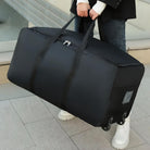 Schwarze Reisetasche mit Rollen, große Kapazität, robuste Griffe, ideal für Reisen.