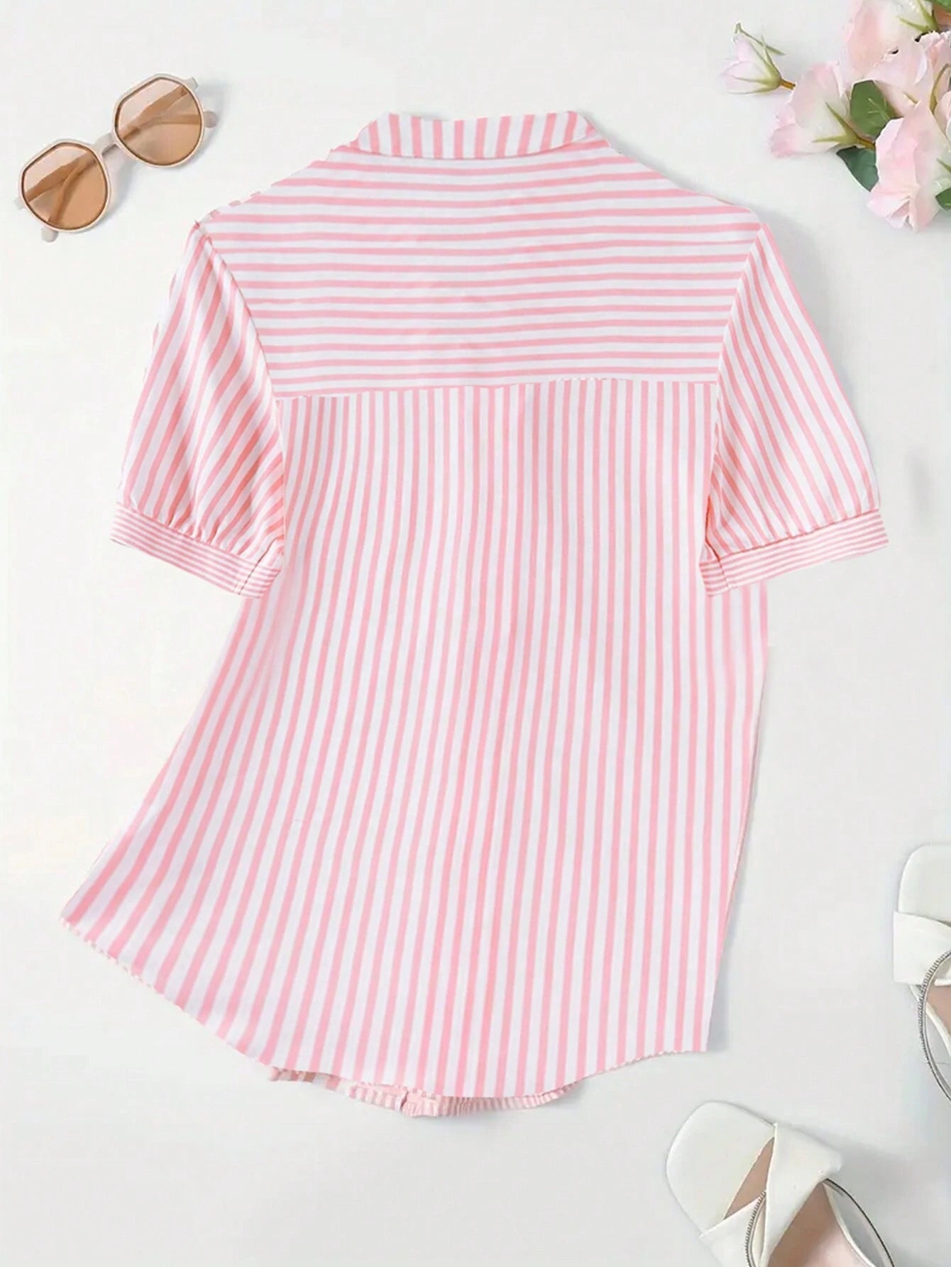 Rosa-weiß gestreiftes Hemd für Damen, kurzärmelig, ideal für Sommermode. Perfekt kombinierbar mit Sonnenbrille und Sandalen.
