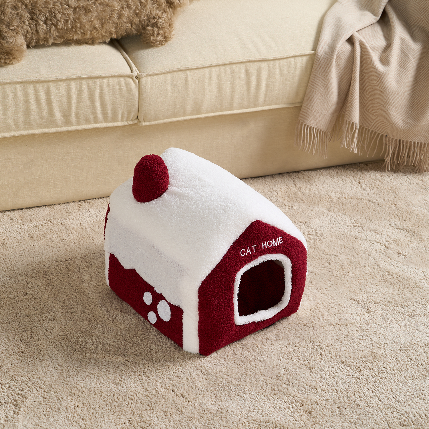 Rotes Katzenhaus aus Plüsch, schneebedeckt, gemütlich, auf Teppich, Haustierbett.