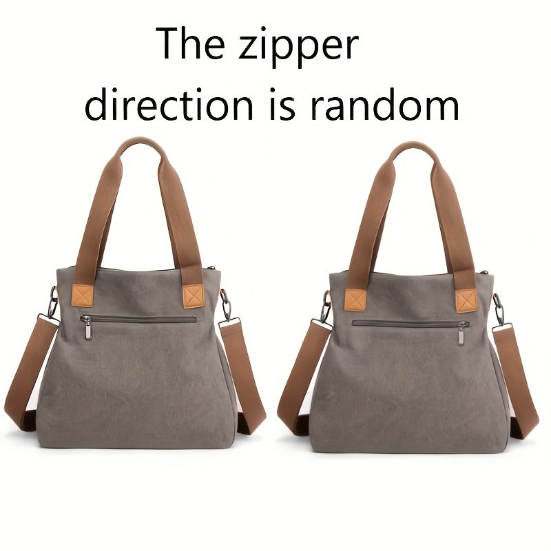 Graue Handtasche mit braunen Griffen und Schulterriemen, Reißverschluss vorne. Stilvoll, vielseitig, ideal für Alltag und Reisen.