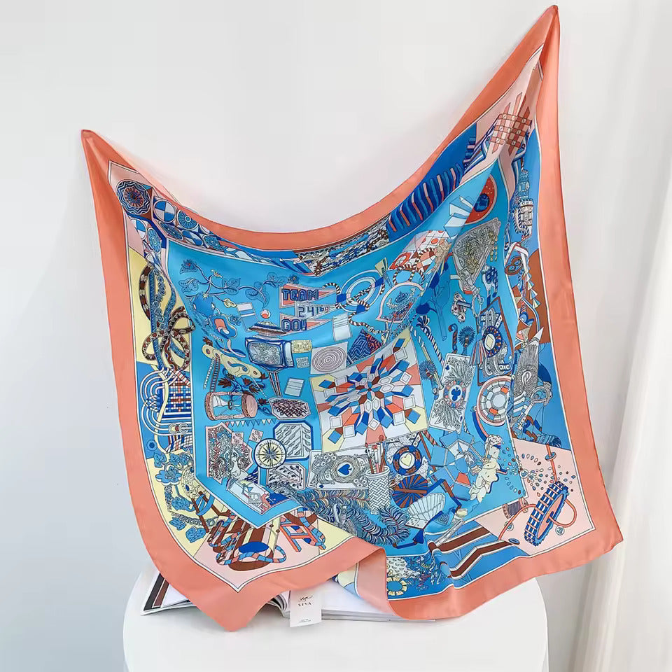 Seidenschal mit buntem geometrischem Muster, blau und orange, modisches Accessoire.