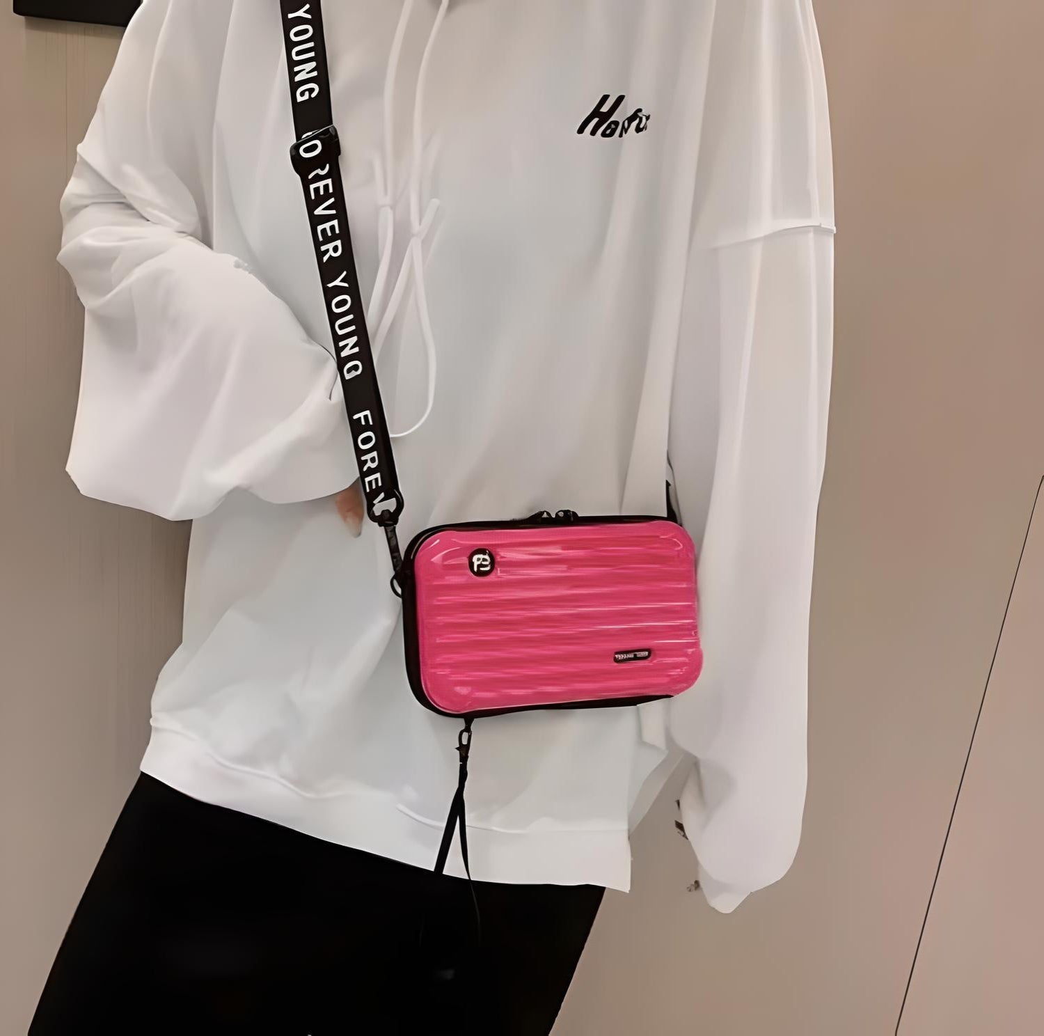 Weiße Kapuzenjacke, pinke Umhängetasche, schwarzer Riemen, modisches Accessoire, Damenmode.