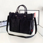Schwarze Cord-Umhängetasche mit Tragegriffen, ideal für Damen. Stilvolle Handtasche, perfekt für Alltag und Büro. Modische Accessoires.