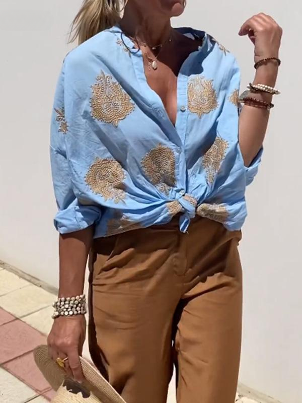 Frau in blauer bestickter Bluse und brauner Hose, Sommermode, lässiger Stil, Accessoires.