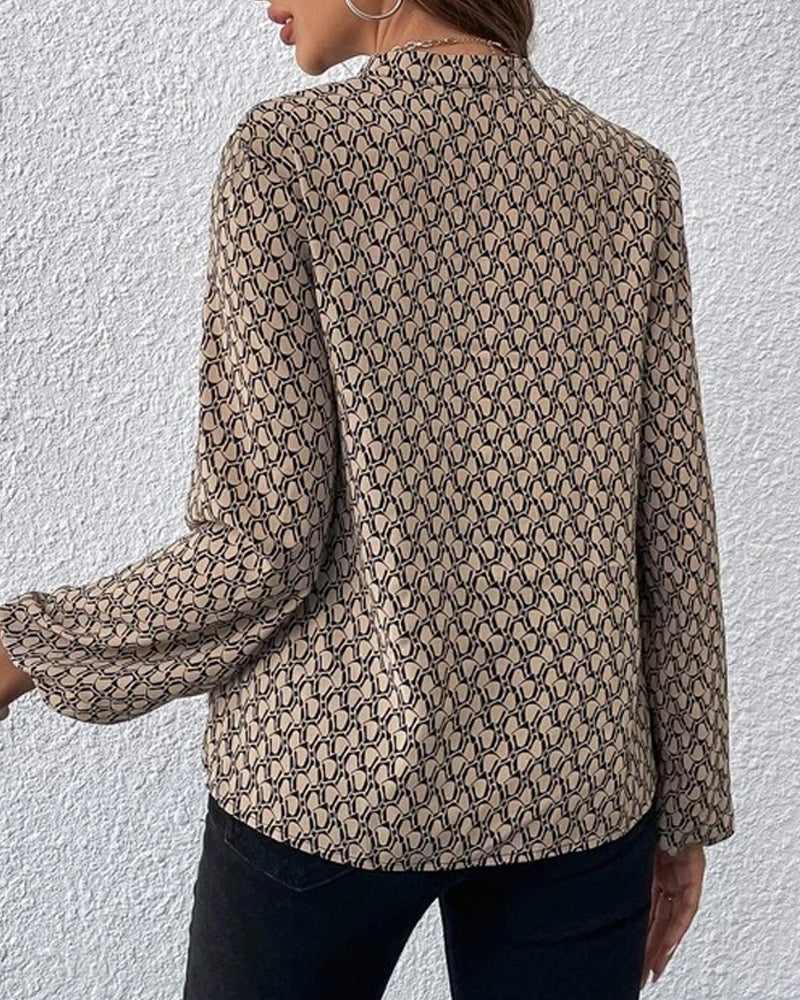 Damenbluse mit geometrischem Muster, langärmlig, beige-schwarz, elegantes Design, ideal für Büro und Freizeit, modische Damenbekleidung.