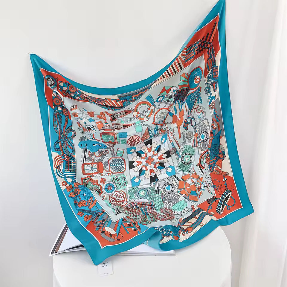 Buntes Seidentuch mit geometrischem Muster, blau-orange, luxuriöses Accessoire, quadratisch.