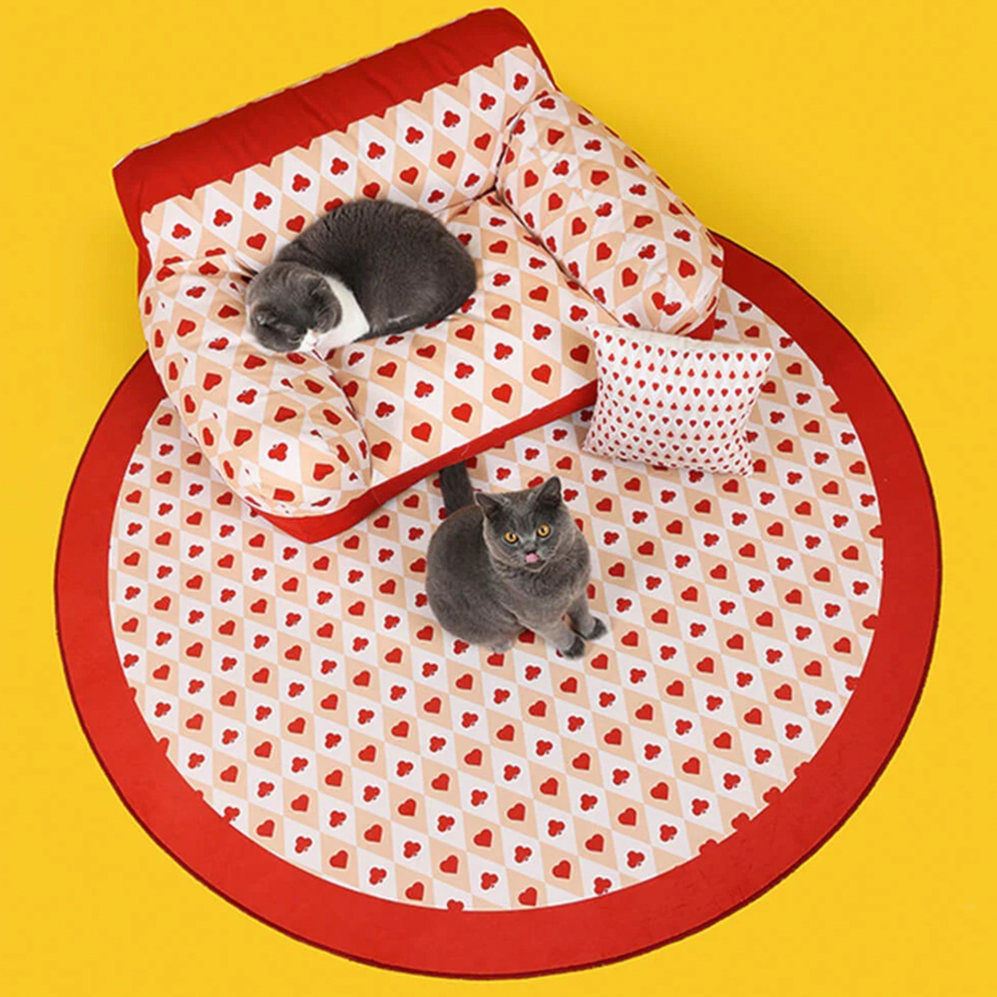 Rotes Herzmuster Haustiersofa mit Katzen, Retro-Stil, gemütliches Hundebett, gelber Hintergrund.