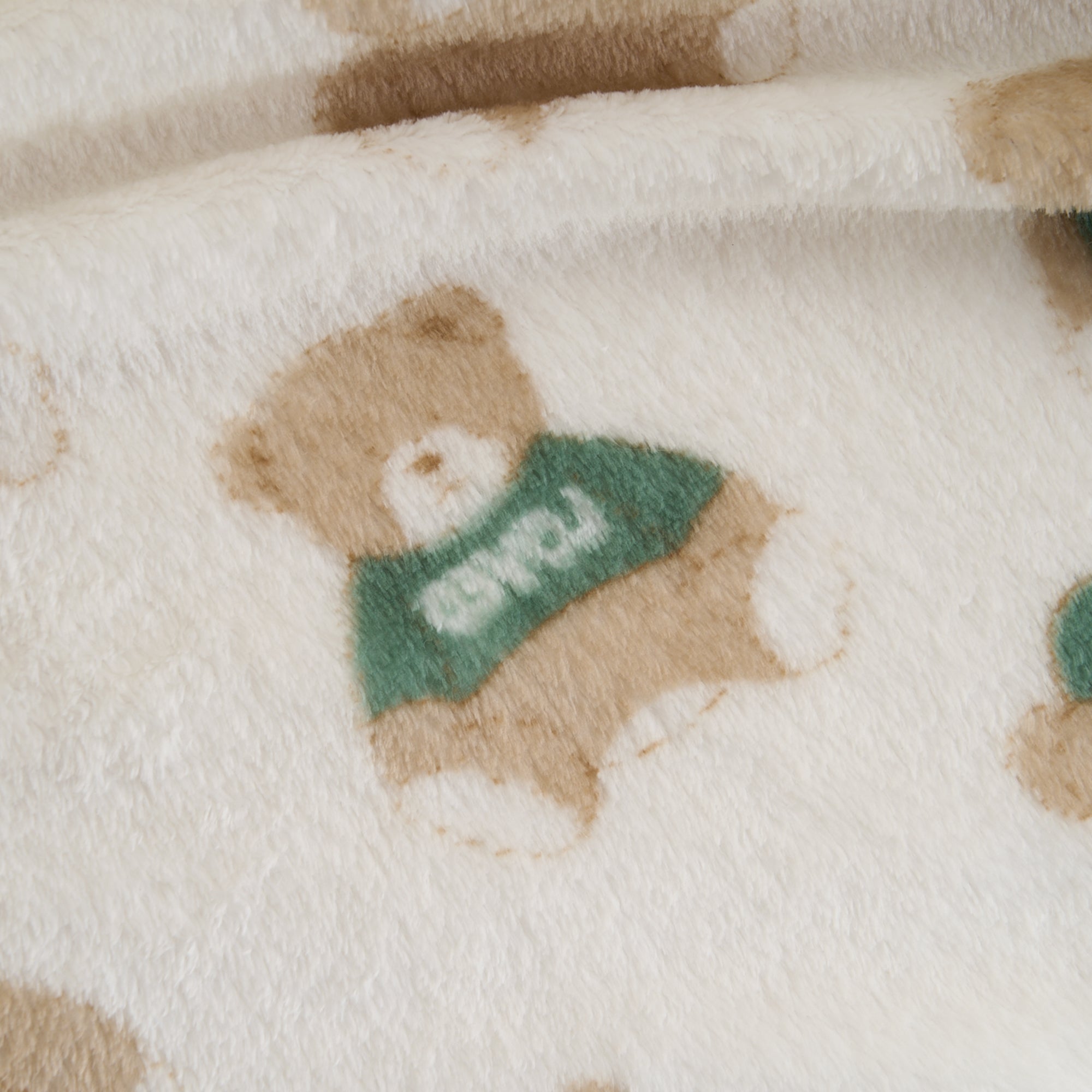 Kuscheldecke mit Teddybär-Motiv, beige und weiß, weiches Material, ideal für Haustiere.