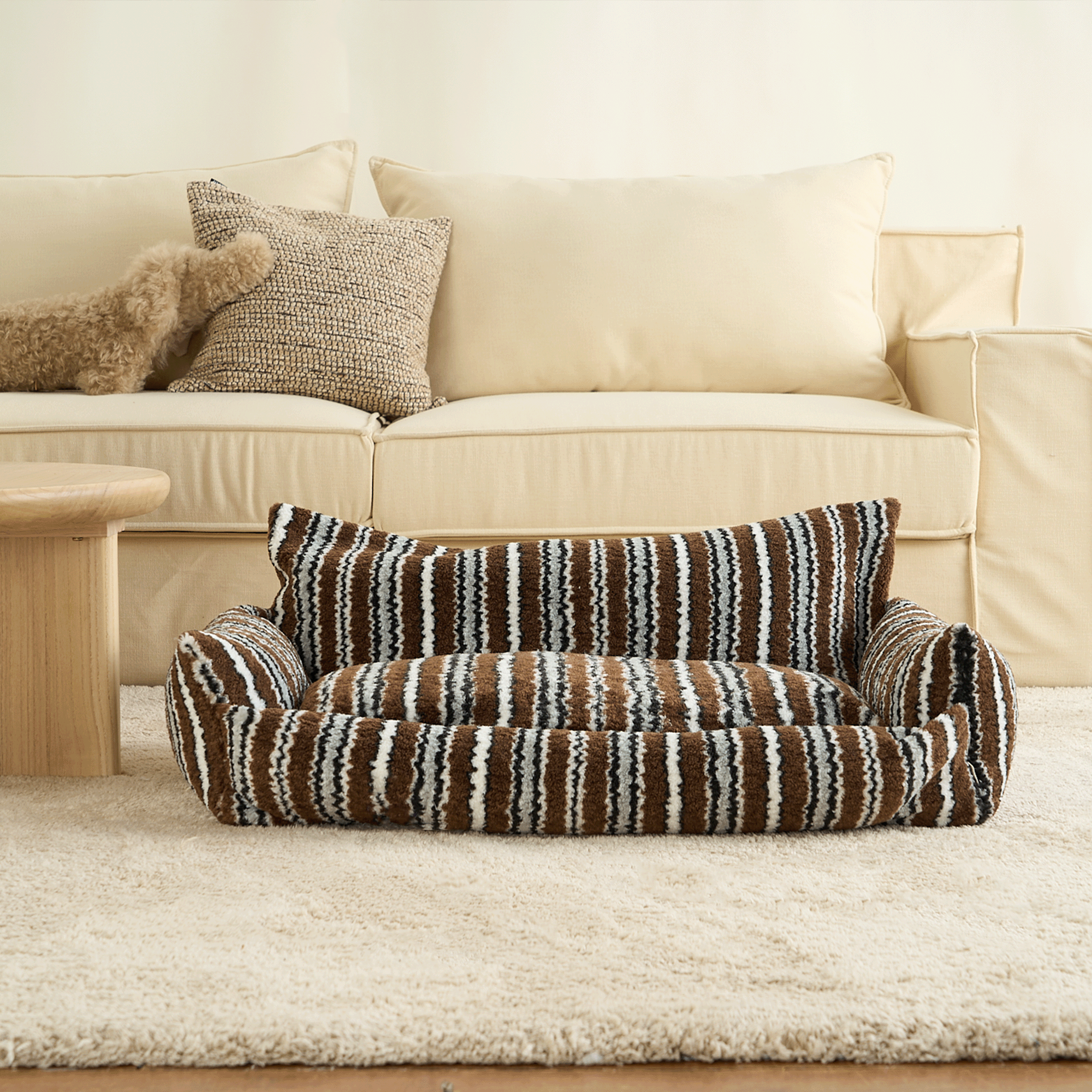 Monochrome gestreiftes Haustiersofa mit Kissen, braun-weiß, gemütlich, modernes Design.