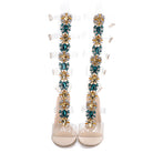 Luxuriöse High Heels mit transparentem Design, verziert mit funkelnden Edelsteinen und floralen Mustern. Perfekt für elegante Anlässe.