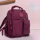 Lila Rucksack, Nylon, mehrere Taschen, Reißverschlüsse, stilvoll, praktisch, Alltag, Schule.