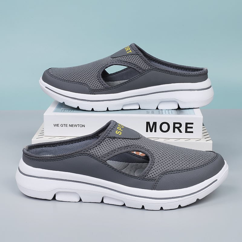 Graue Sportschuhe mit atmungsaktivem Mesh-Obermaterial und weißer Sohle, ideal für Freizeit und Outdoor-Aktivitäten. Komfortable und stilvolle Clogs.