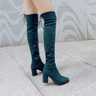 Dunkelgrüne Overknee-Stiefel mit Blockabsatz, Schnürung und Reißverschluss, ideal für modische Herbst- und Winteroutfits.