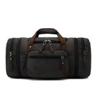 Schwarze Lederreisetasche mit mehreren Reißverschlusstaschen und braunen Griffen.
