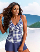 Frau im karierten Badeanzug am Strand, lächelnd, mit langen Haaren. Sommermode, Strandkleidung, Damenbademode, Urlaub, Meer, blau-weißes Design.