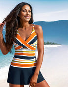 Frau im gestreiften Badeanzug am Strand, lächelnd vor tropischer Kulisse. Sommermode, Strandkleidung, Urlaub, Bademode, tropisches Paradies.