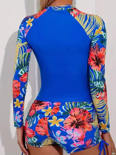 Bunter Badeanzug mit tropischem Blumenmuster, langärmlig, ideal für Strand und Schwimmen. Modische Bademode für Damen, UV-Schutz.