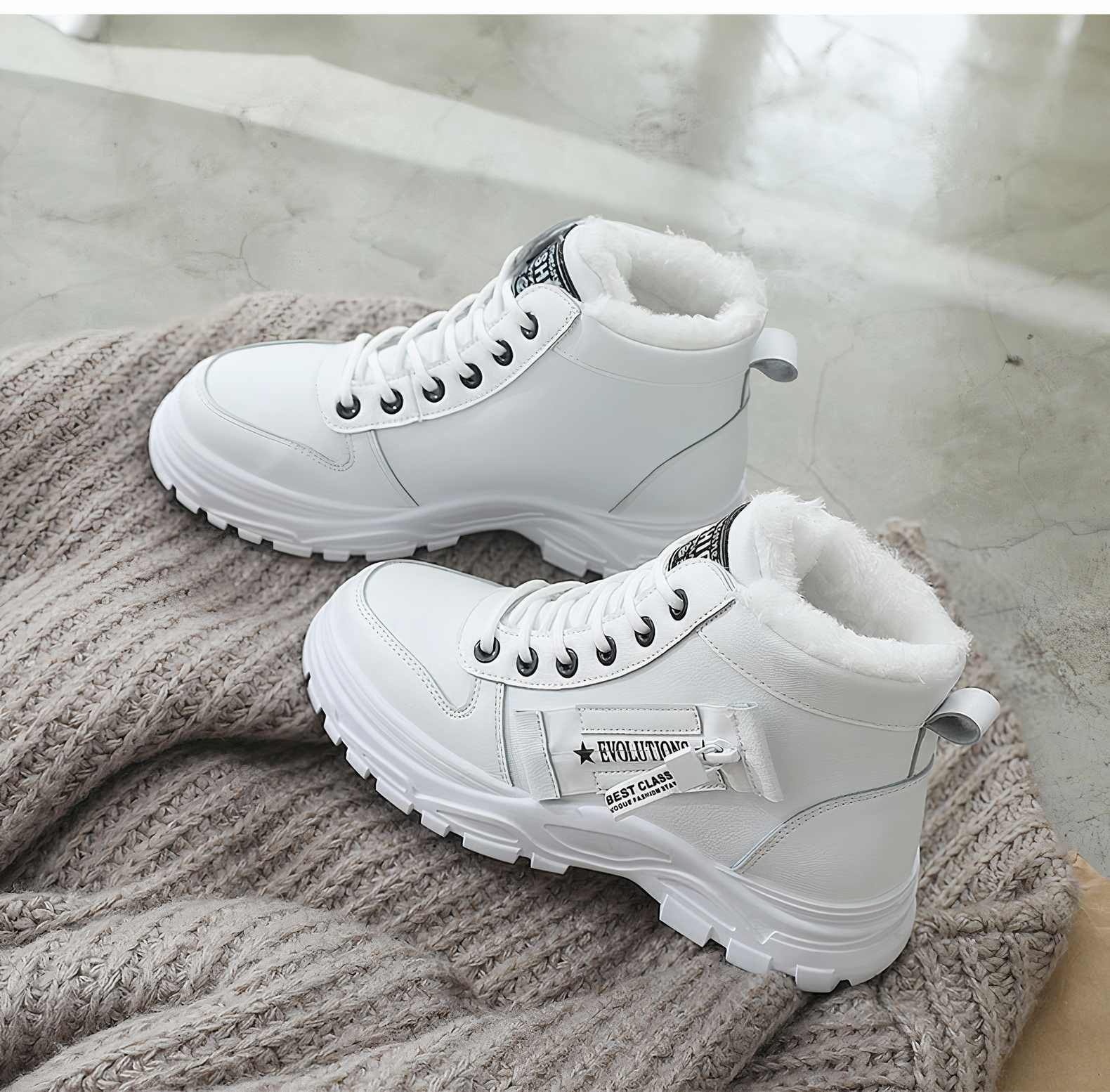 Weiße Winterstiefel mit Fellfutter, robustem Profil und Schnürung auf grauem Strickhintergrund. Perfekt für kalte Tage und modische Outfits.