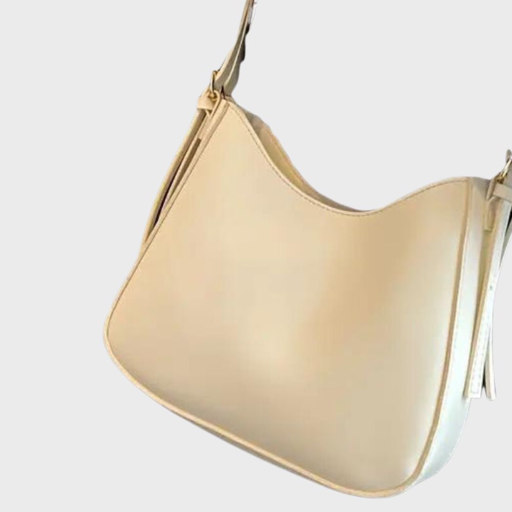 Elegante cremeweiße Handtasche aus Leder, ideal für Damenmode. Stilvoll und vielseitig, perfekt für Alltag und besondere Anlässe.