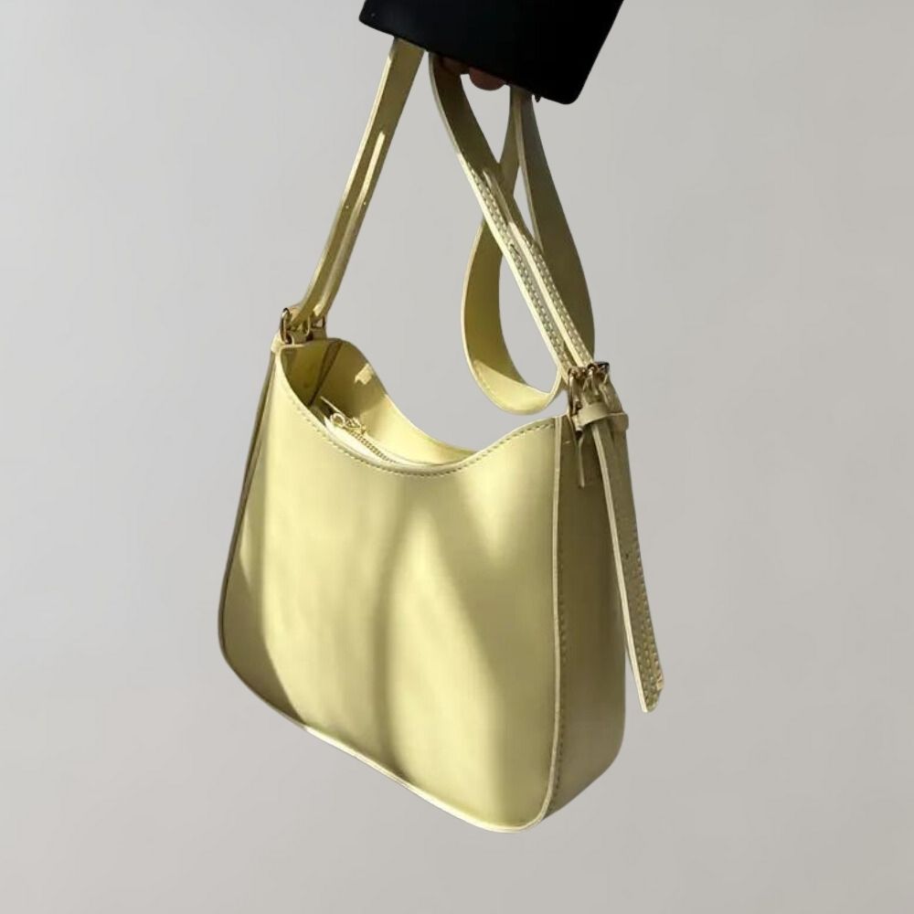 Elegante gelbe Handtasche aus Leder mit verstellbarem Schulterriemen. Perfekt für Damenmode, stilvolles Accessoire für jeden Anlass.