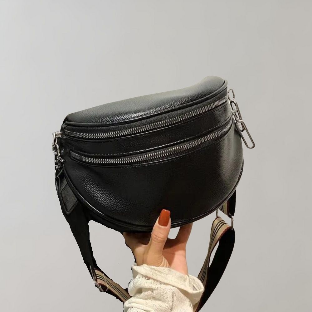 Schwarze Leder-Gürteltasche mit Doppelreißverschluss, verstellbarem Riemen und modernem Design. Perfekt für stilvolle, praktische Aufbewahrung.