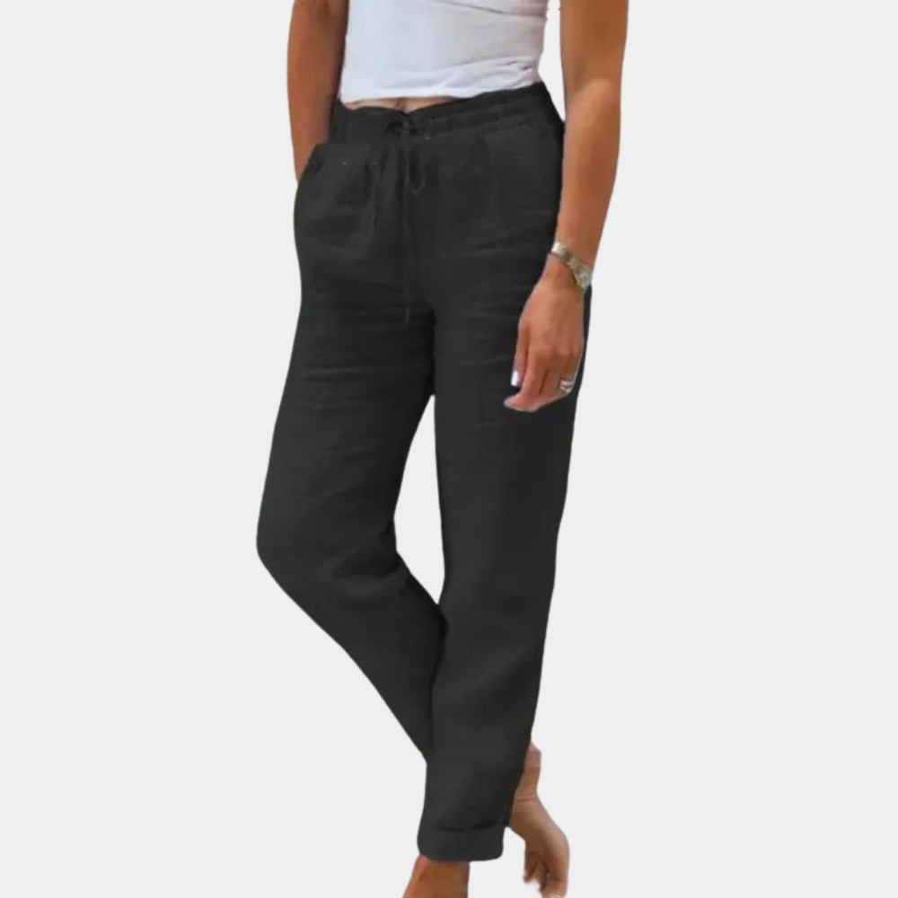 Frau in schwarzer Leinenhose, lässig, bequem, Sommermode, Damenbekleidung, weißes Top.