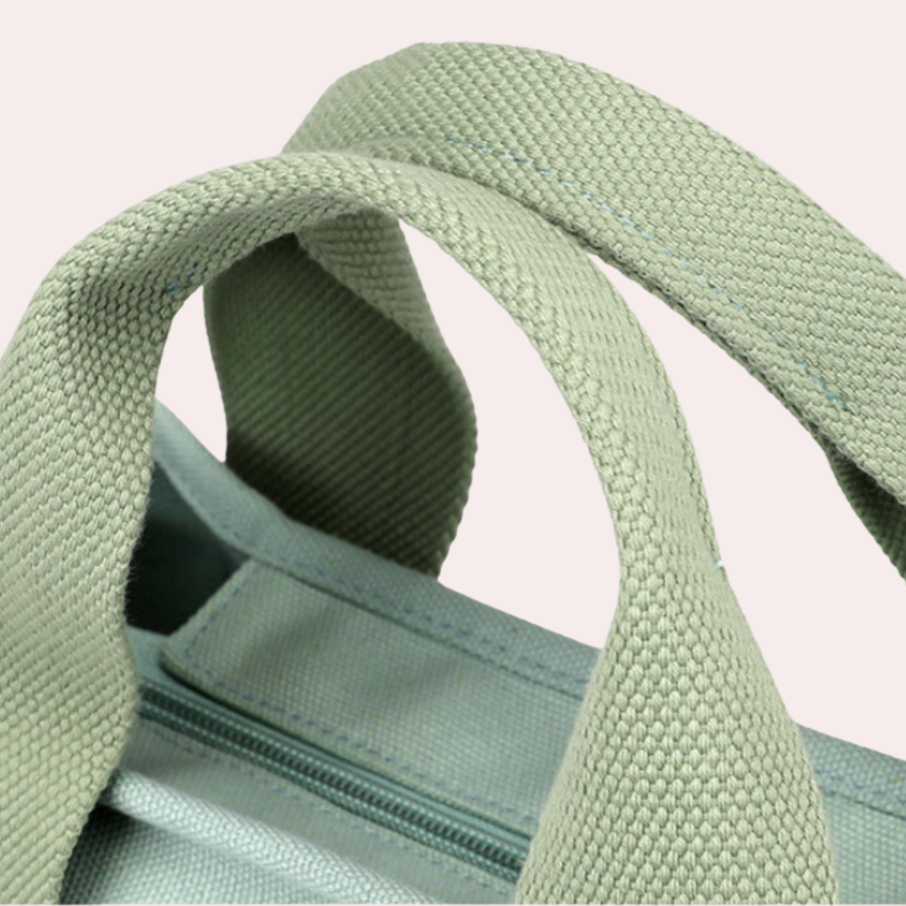 Grüne Canvas-Tasche mit robusten Trägern und Reißverschluss. Stilvolle, nachhaltige Handtasche für Alltag und Reisen. Hochwertiges Design.