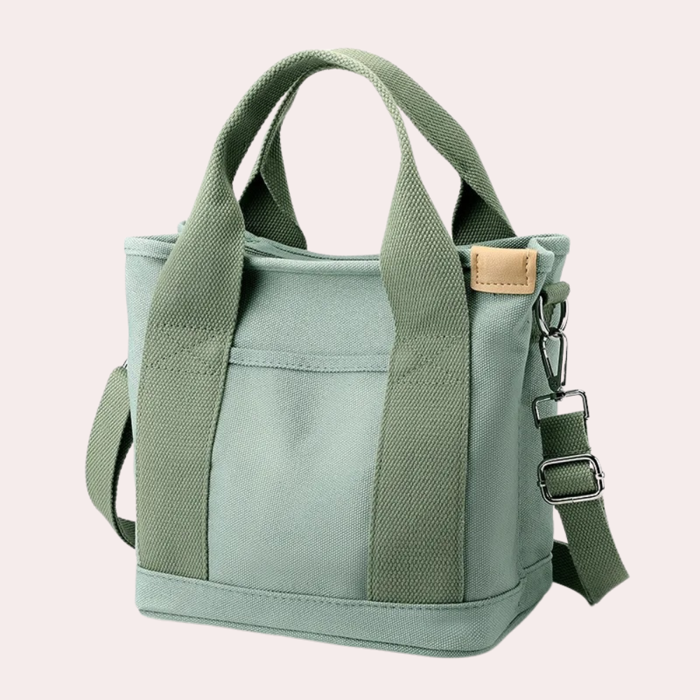 Grüne Canvas-Tasche mit verstellbarem Schultergurt, robusten Tragegriffen und modernem Design. Perfekt für Alltag und Freizeit.