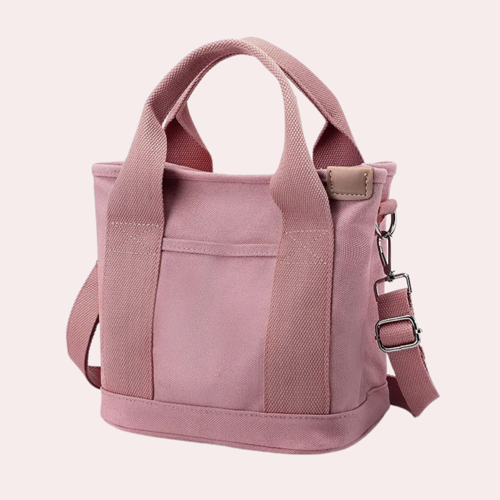 Rosa Canvas-Tasche mit verstellbarem Schultergurt, ideal für Alltag und Reisen. Stilvoll, robust und vielseitig einsetzbar.