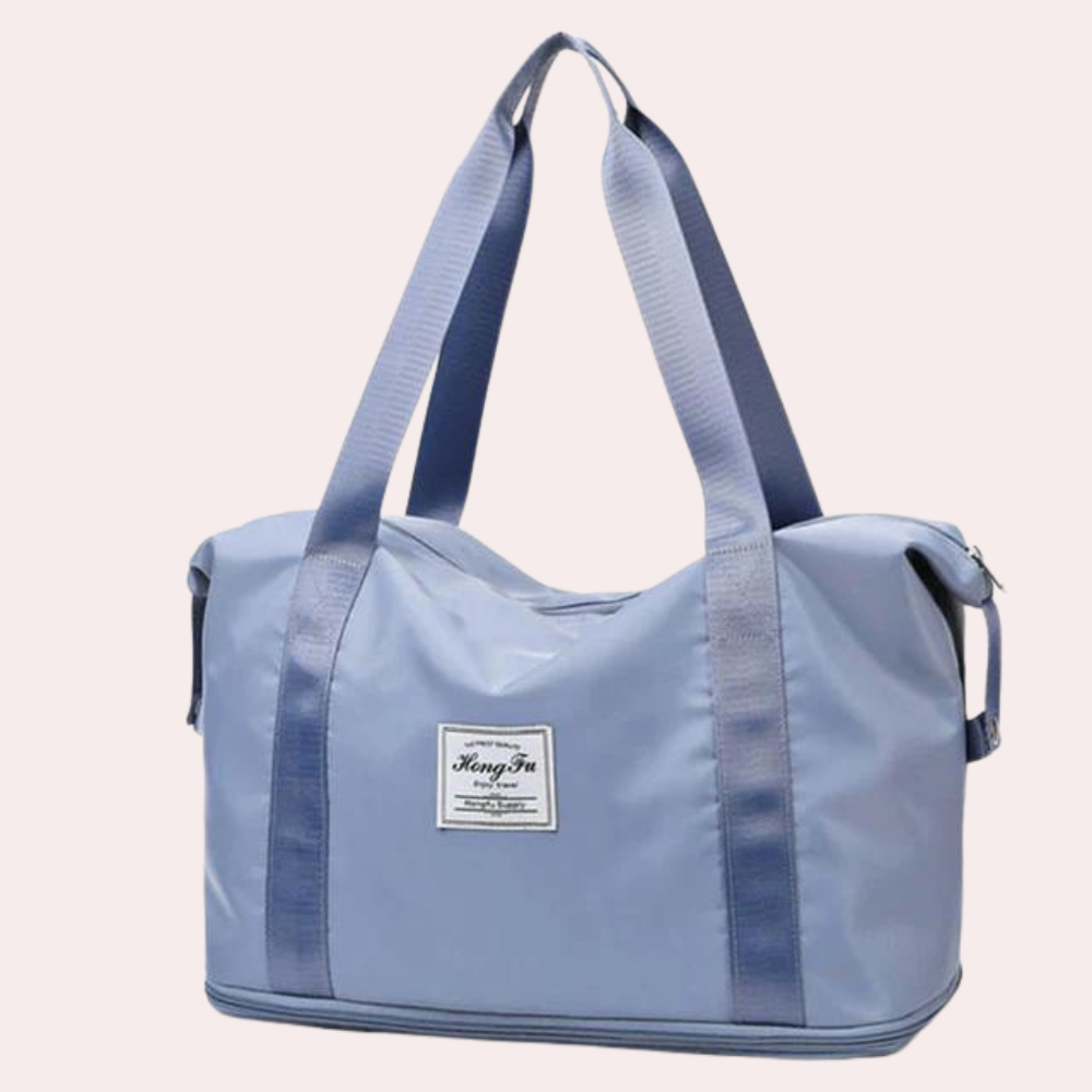 Blaue Sporttasche aus strapazierfähigem Material mit robusten Trägern und Reißverschluss. Perfekt für Fitnessstudio und Reisen.