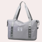 Graue Reisetasche mit robusten Trägern, ideal für Reisen und Sport. Stilvolles Design, geräumig, langlebig. Perfekt für Damen und Herren.