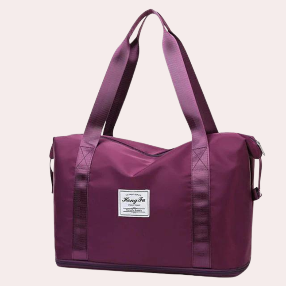 Weinrote Reisetasche aus strapazierfähigem Material mit robusten Trägern und Reißverschluss. Perfekt für Reisen und Alltag.