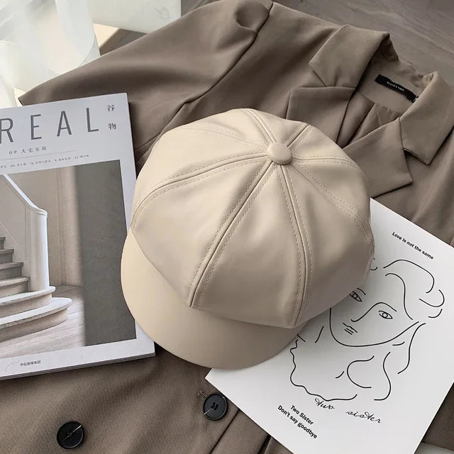 Beige Leder-Newsboy-Cap auf braunem Mantel, stilvoll und modern. Perfekt für Herbst und Winter. Hochwertige PU-Leder, koreanisches Design.