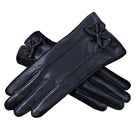 Elegante schwarze Lederhandschuhe mit Schleifendetail, ideal für Damenmode. Perfekt für Herbst und Winter, stilvoll und warm.