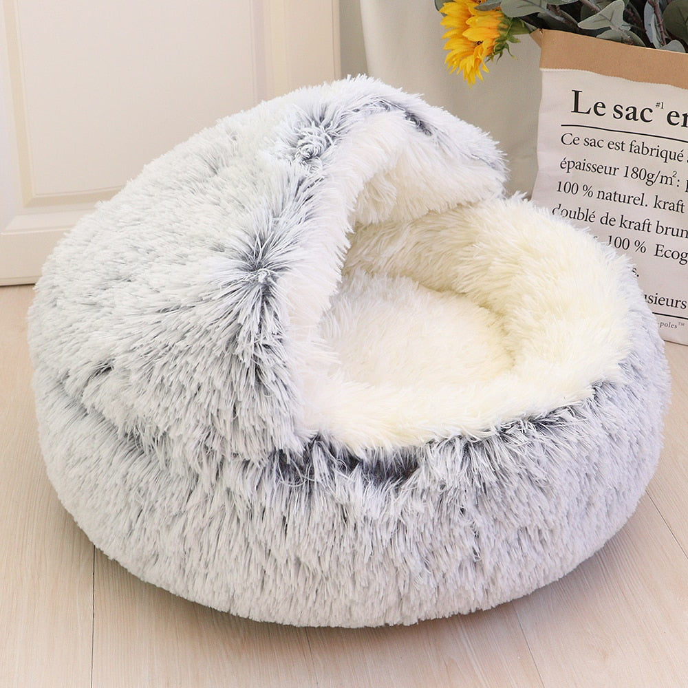 Weiches, rundes Katzenbett aus Plüsch in Grau und Weiß, ideal für Haustiere. Gemütlicher Schlafplatz, perfekt für Katzen und kleine Hunde.