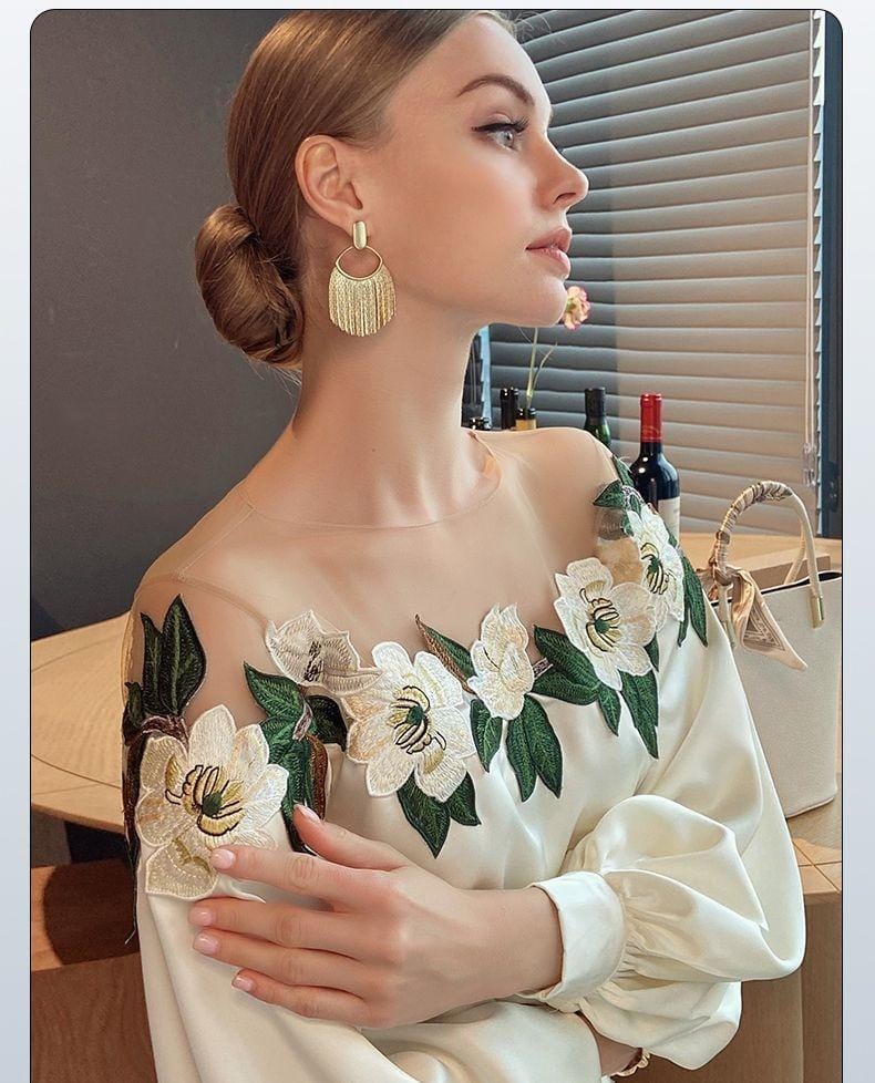 Elegantes Damenkleid mit floralen Stickereien, langen Ärmeln und transparentem Ausschnitt. Perfekt für stilvolle Anlässe und modische Events.