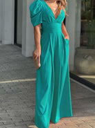 Elegantes, türkisfarbenes Maxikleid mit Puffärmeln und V-Ausschnitt, ideal für Sommermode und festliche Anlässe. Perfekt für stilvolle Auftritte.