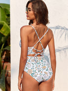 Damen-Badeanzug mit floralem Muster, Rückenausschnitt und überkreuzten Trägern. Perfekt für Strandmode und Sommerurlaub. Hochwertige Bademode.