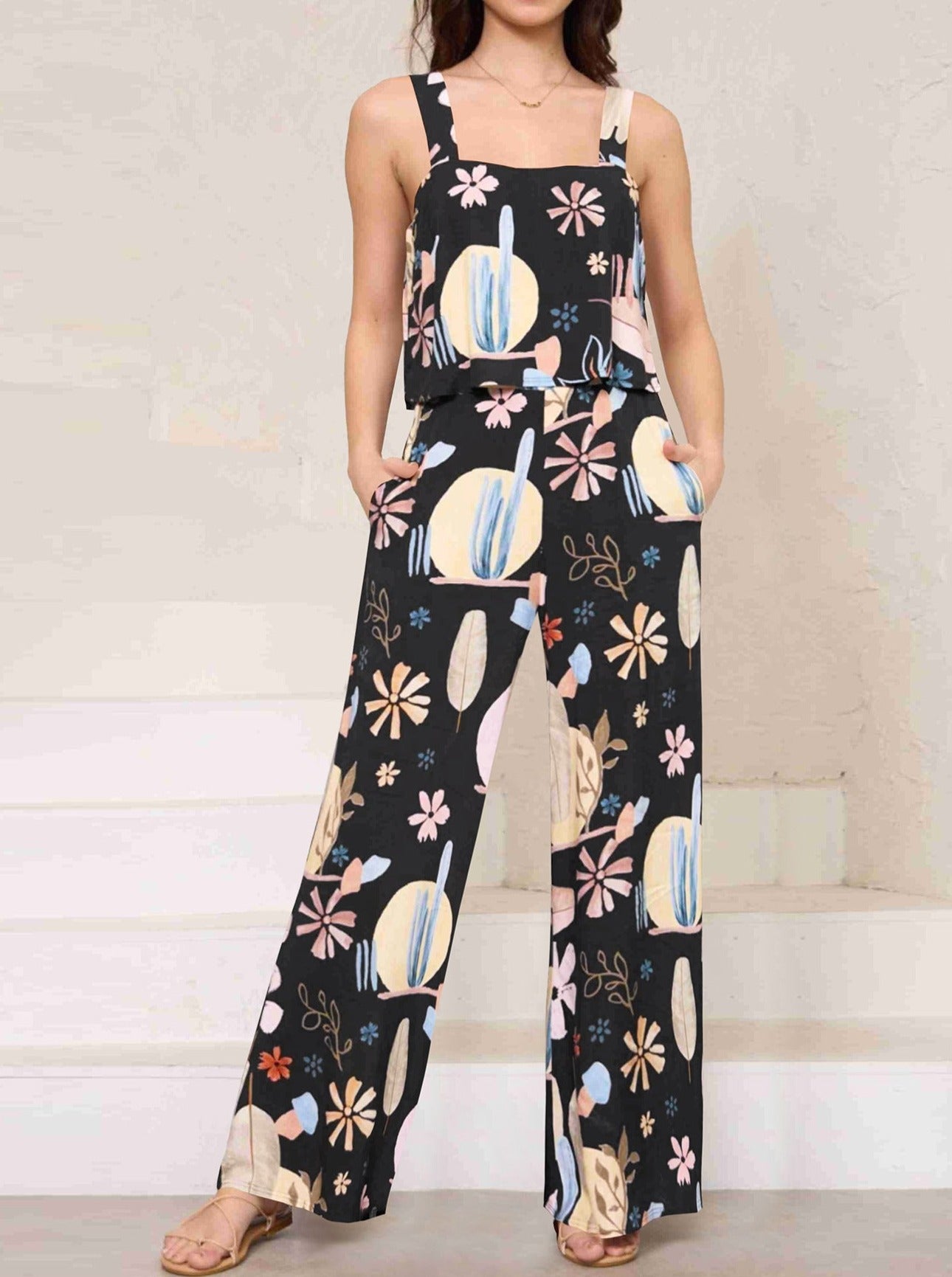 Damen Jumpsuit mit abstraktem Blumenmuster, ärmellos, schwarz, lässig, modisch, ideal für Sommermode und Freizeitkleidung.