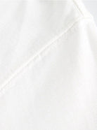 Weißes Baumwoll-T-Shirt, Nahaufnahme der Naht. Hochwertiger Stoff, ideal für lässige Mode. Perfekt für Sommerkleidung und Alltagsoutfits.