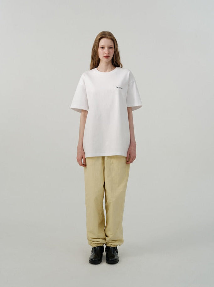 Damenmode: Weißes Oversize-T-Shirt und beige Hose, minimalistisch, lässig, modern. Perfekt für trendige, bequeme Alltagsoutfits.