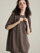 Frau in lockerem, braunem Oversize-T-Shirt, modisch und lässig. Perfekt für trendige Streetwear-Looks. Ideal für Freizeit und Alltag.