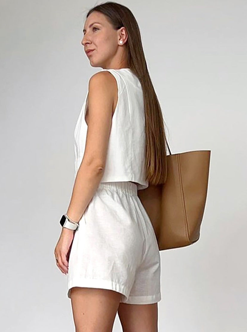 Frau in weißem Sommeroutfit mit brauner Ledertasche, trägt Smartwatch. Modetrend, Damenmode, Sommerlook, stilvoll, lässig, Accessoires.