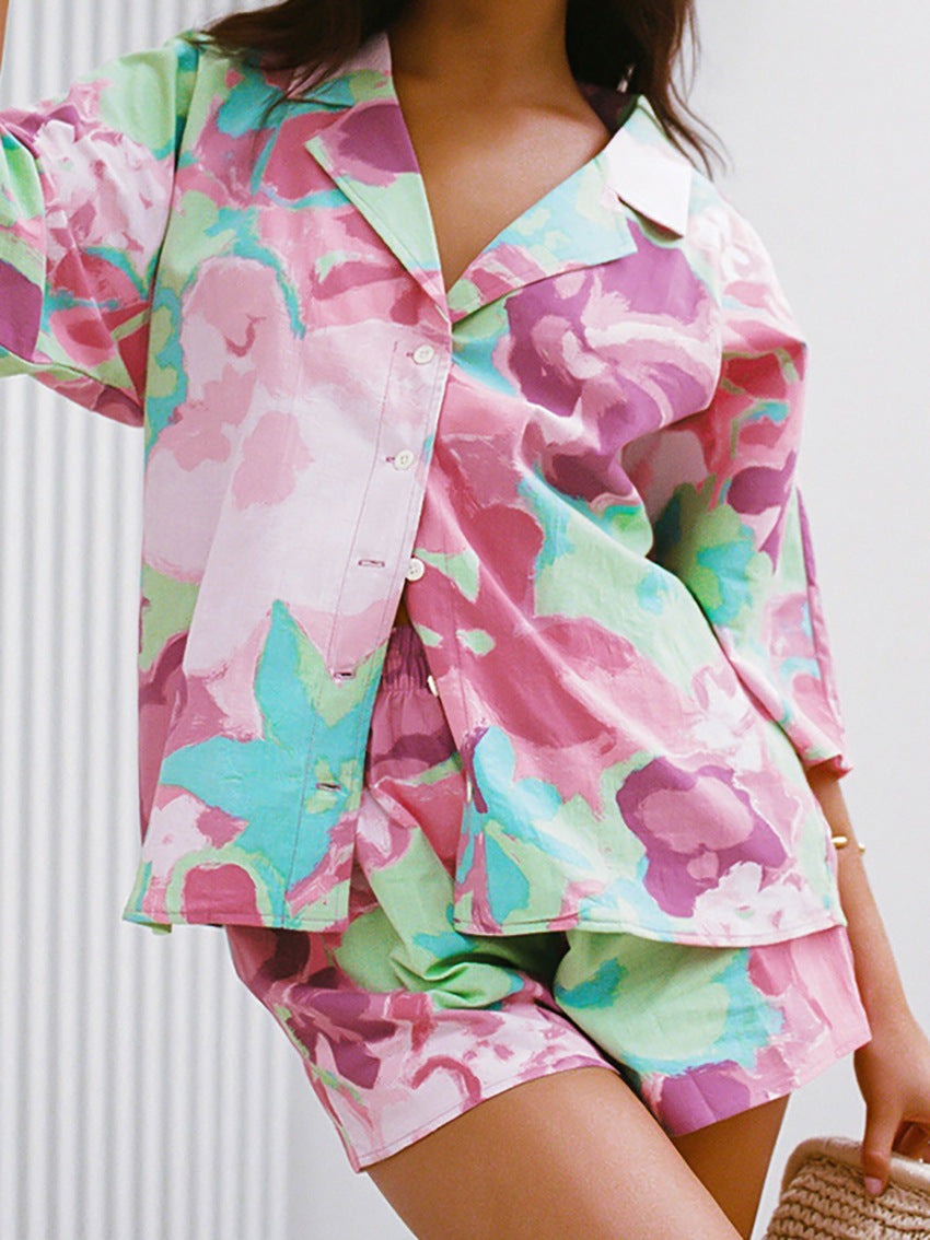 Farbintensiver Pyjama-Set mit floralem Muster, bestehend aus Hemd und Shorts. Perfekt für bequeme Nächte und stilvolle Loungewear.